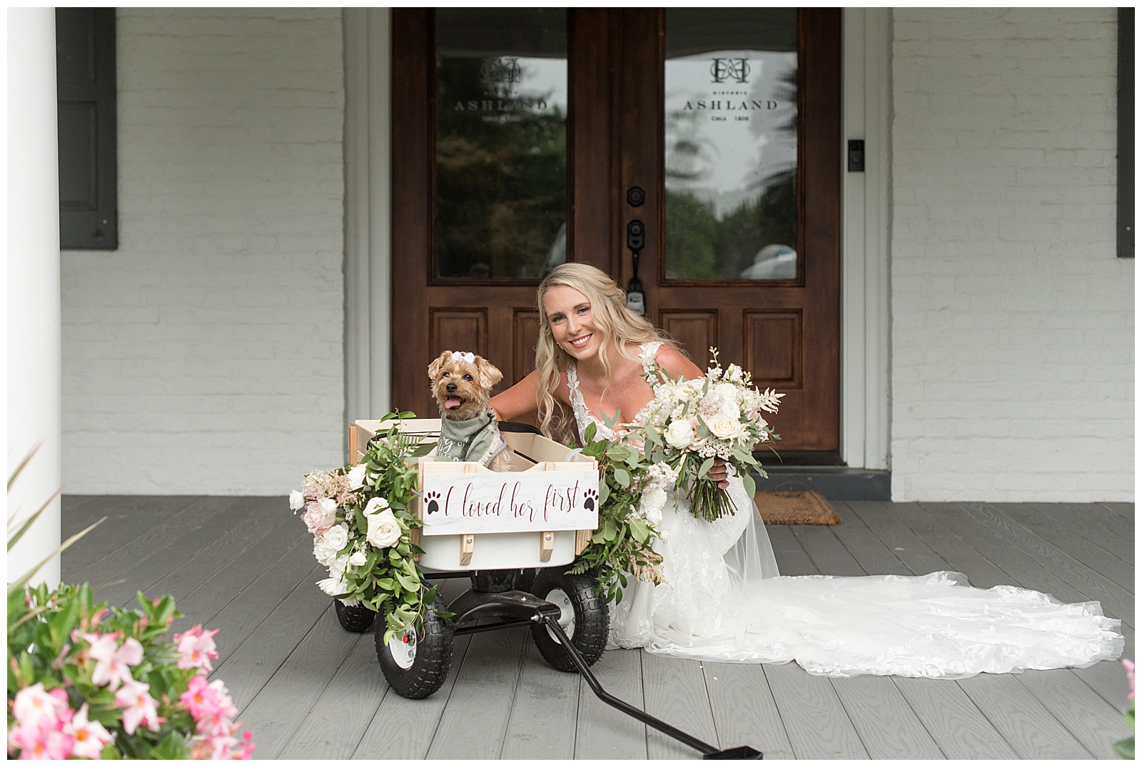 bride's crouched down beside decorated wagon with her pet dog inside at historic ashland