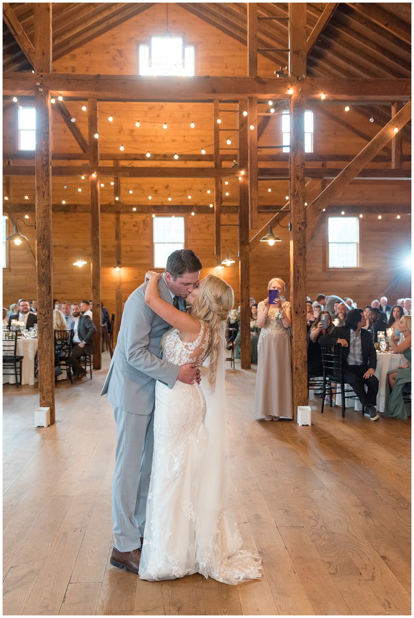 couple sharing a kiss during their first dance at barn wedding reception at historic ashland in wrightsville pennsylvania