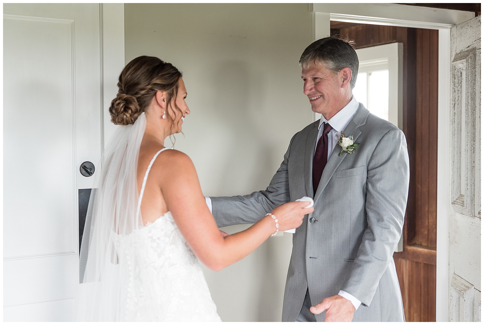bride sharing a first look moment with her dad inside bridal suite at lakefield weddings in manheim pennsylvania
