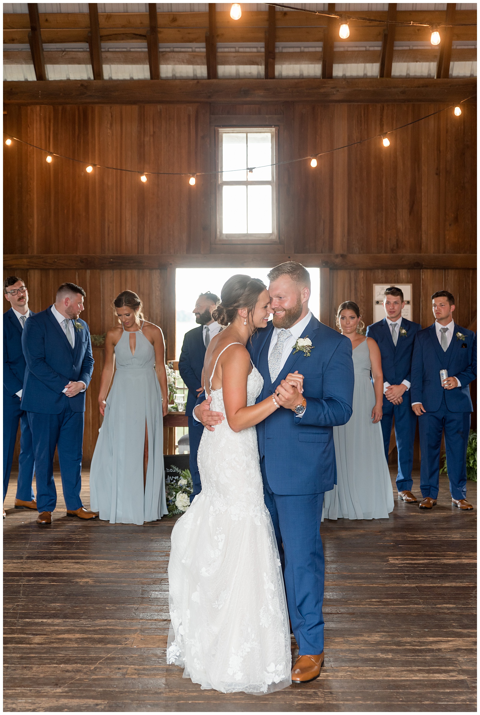 couple sharing their first dance inside beautiful barn reception at lakefield weddings