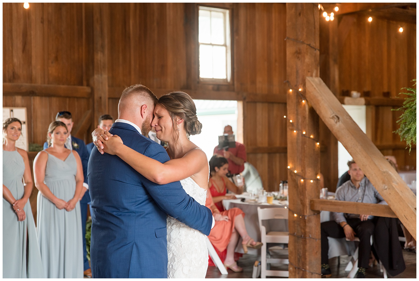 bride and groom slow dancing inside their barn wedding reception at lakefield weddings in manheim pennsylvania