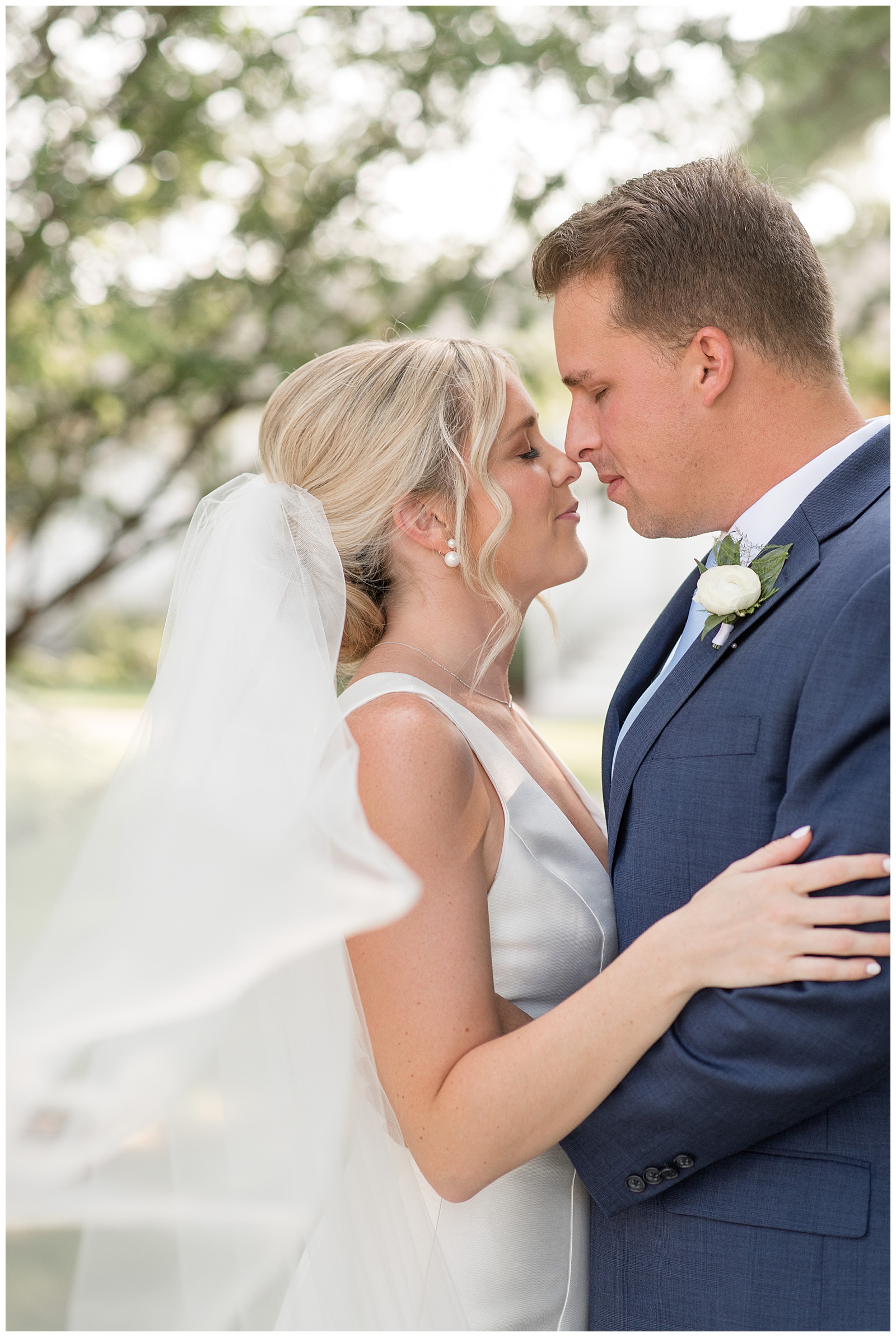 bride and groom hugging with noses touching and eyes closed at wylder hotel on tilghman island in maryland