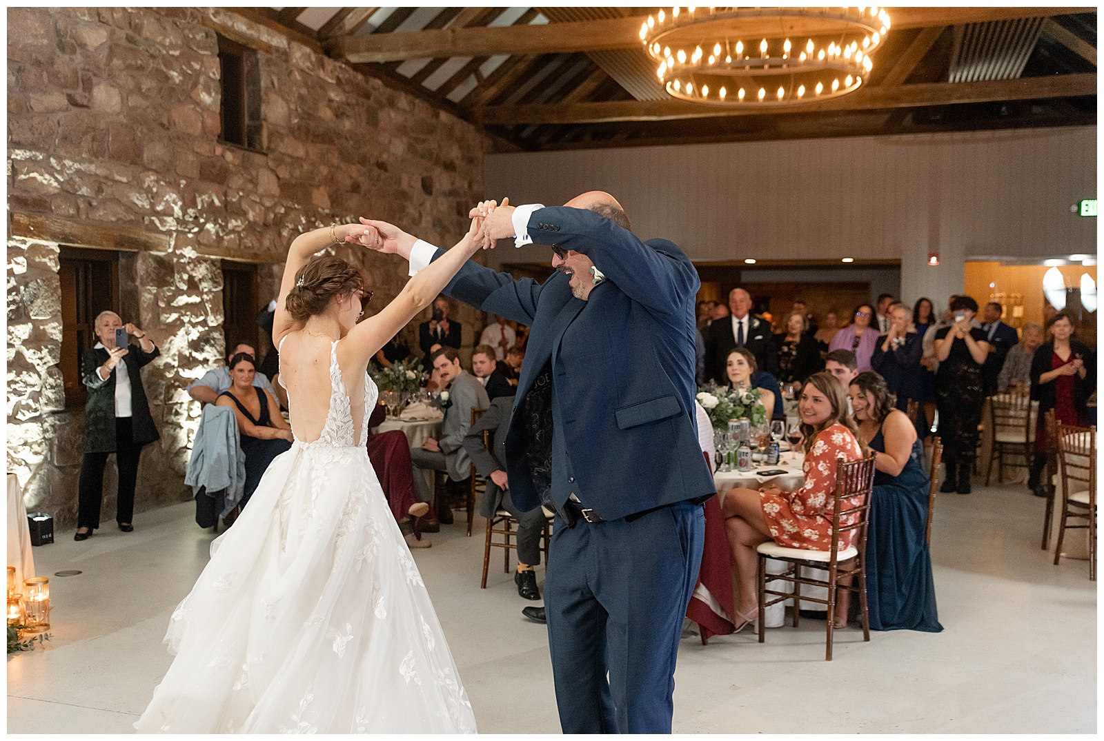 bride dancing with her father who wearing a navy suit and spinning his daughter on dance floor at elizabeth furnace