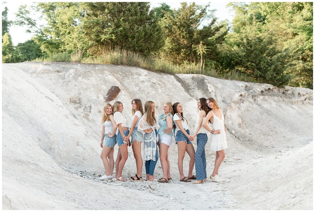 eight senior girl spokesmodels standing in different directions and against one another on the white cliffs of conoy
