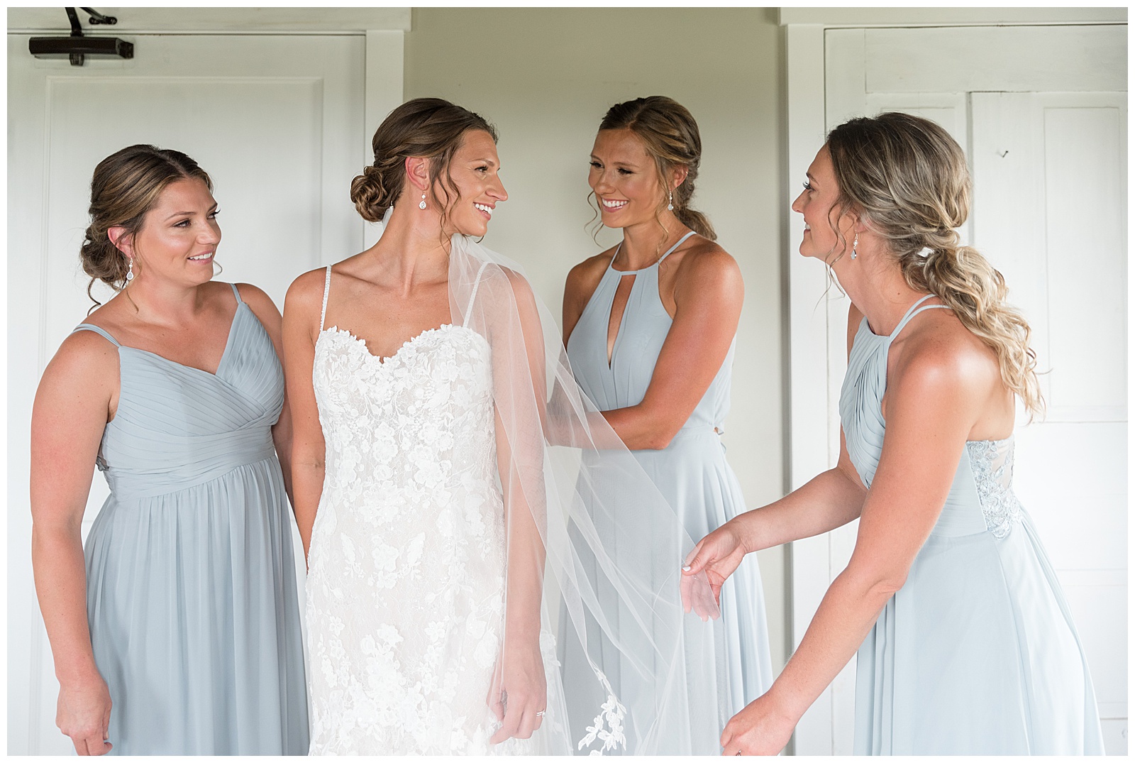 bride with her three bridesmaids wearing light blue gowns in bridal suite at lakefield weddings in manheim pennsylvania