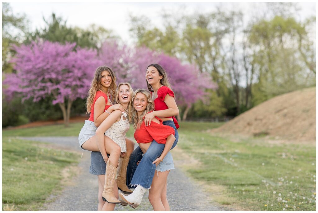 four senior spokesmodels giving piggyback rides as everyone smiles at spring photoshoot at overlook park