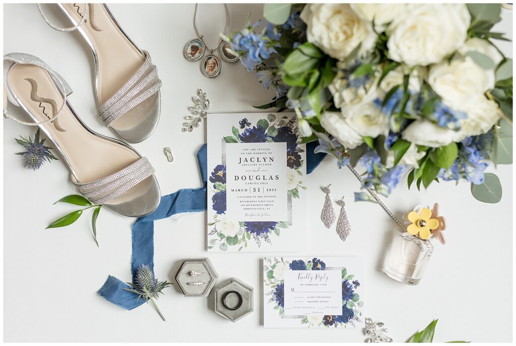 beautiful display of wedding invitation with wedding rings and jewelry and bride's shoes in blues and yellows and whites in pennsylvania