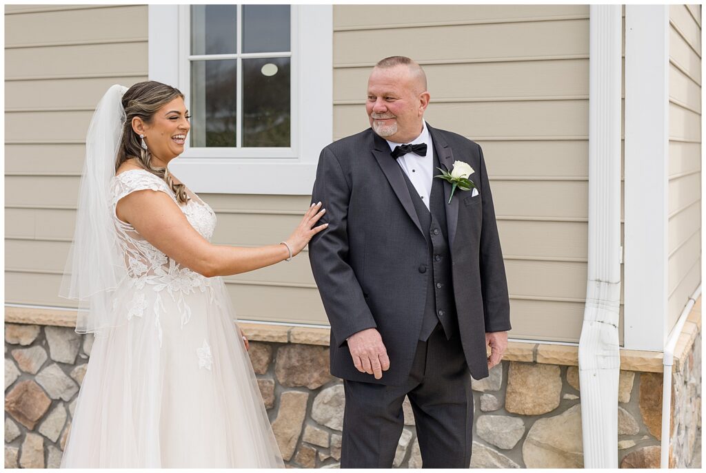 bride sharing a first look moment with her dad outdoors as she touches his right arm at rivercrest golf club