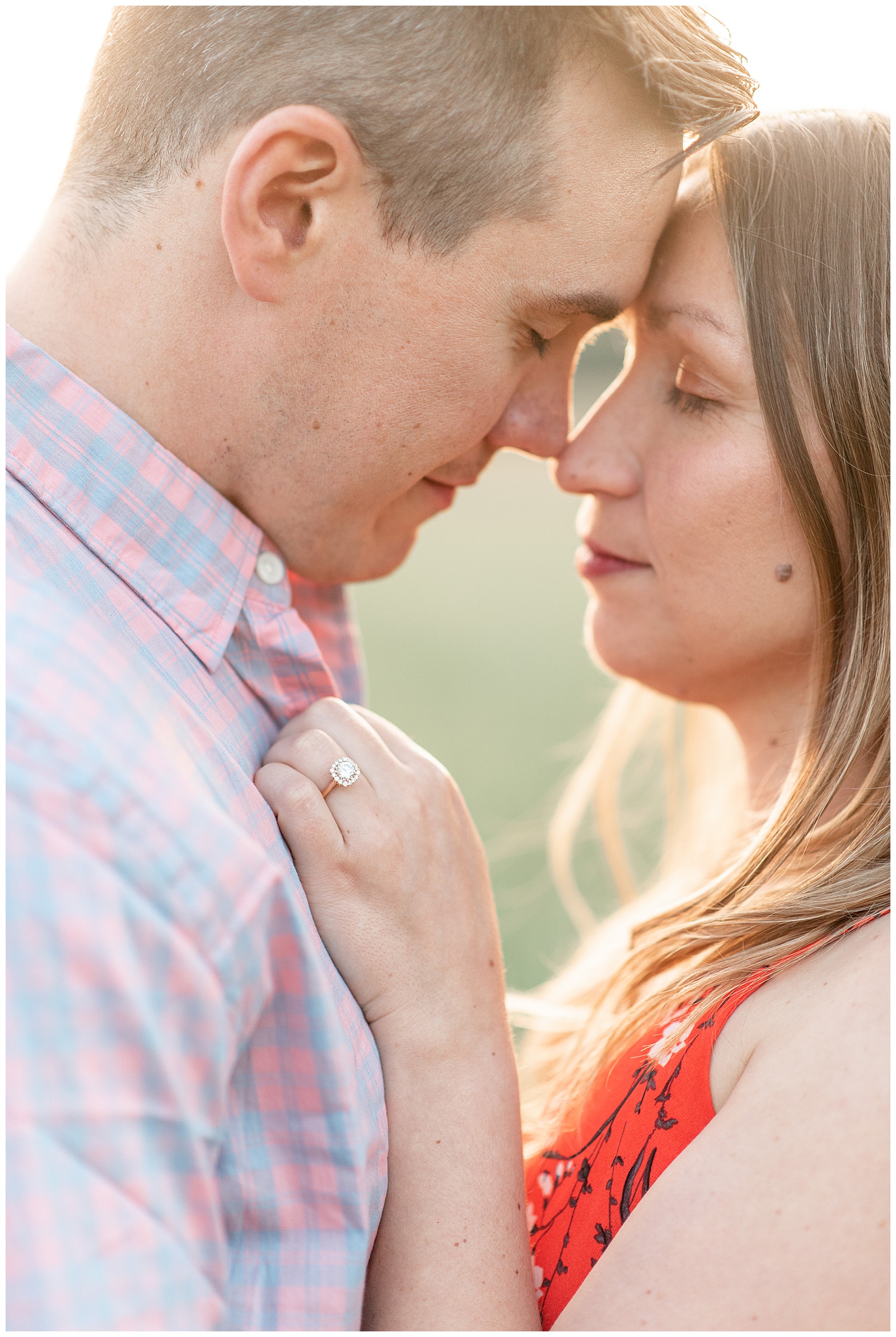 close up photo of couple touching foreheads with their eyes closed on sunny evening in pennsylvania
