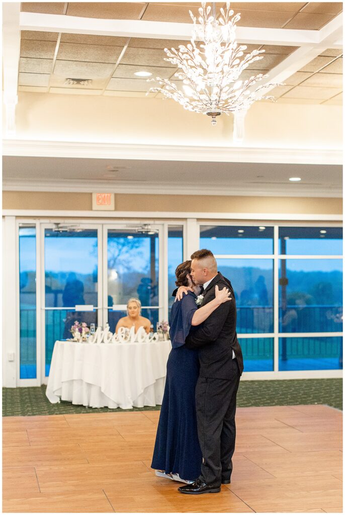 groom and his mom hugging tightly during their dance at reception at maryland golf and country club