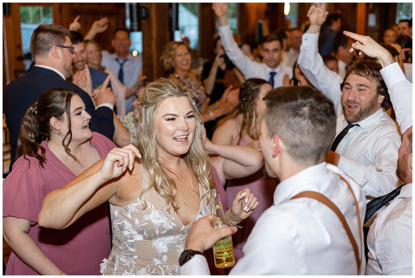 bride and groom dance with their guests during barn wedding reception at the barn at silverstone
