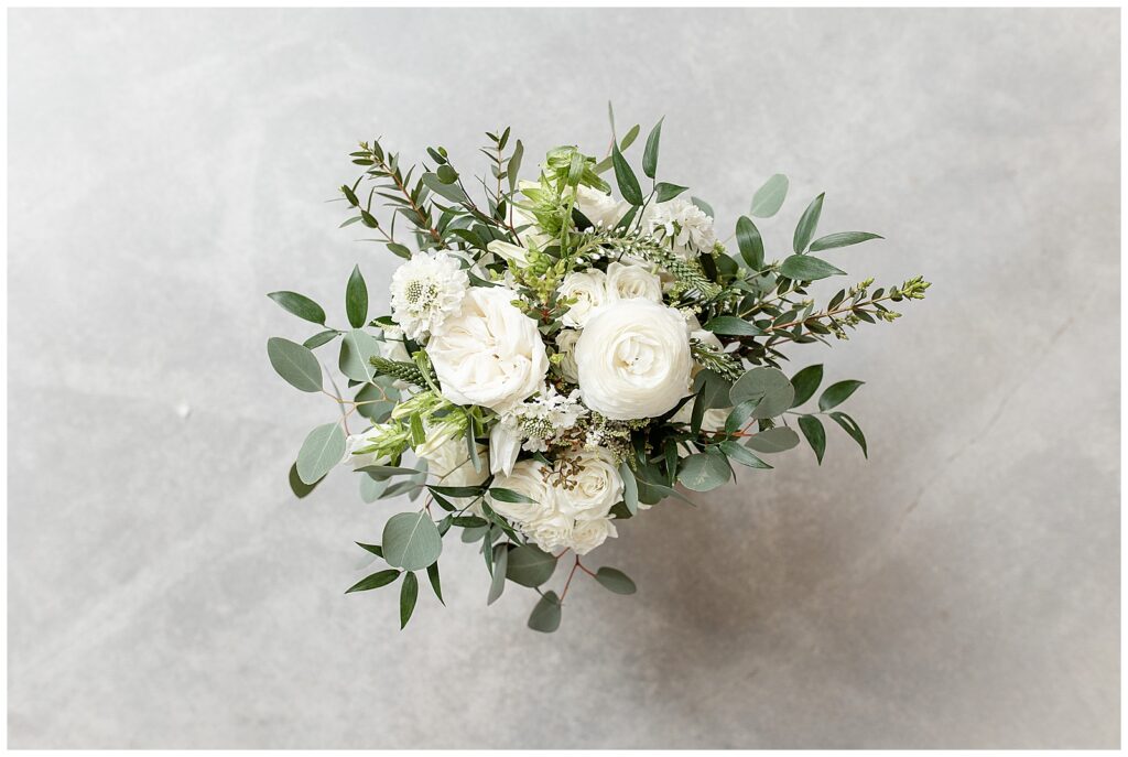bouquet of white flowers and eucalyptus on gray background at elizabeth furnace