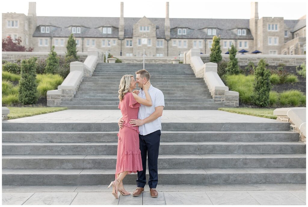 couple almost kissing by large outdoor staircase and huge building behind them at masonic village in elizabethtown pennsylvania