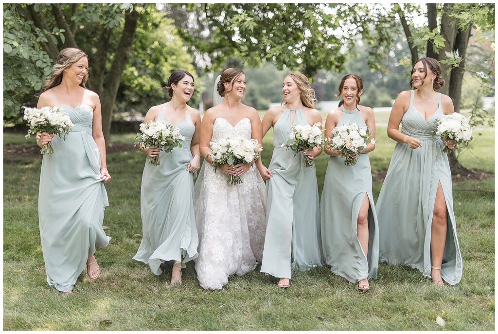 bride with her five bridesmaids in sage green gowns all walking towards camera holding bouquets in wrightsville pennsylvania