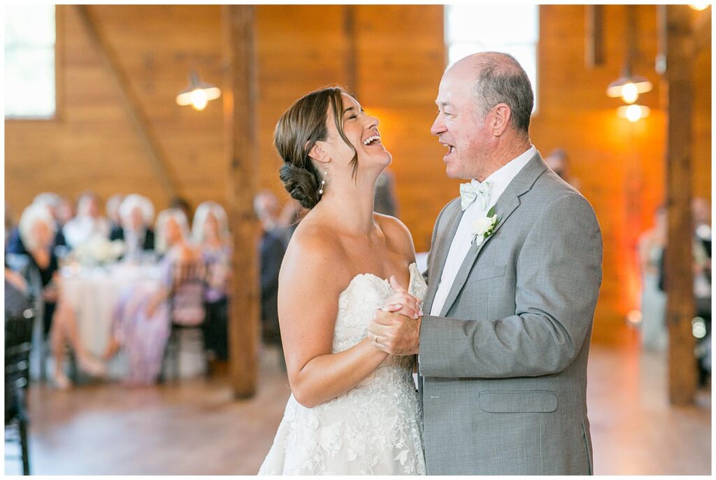 bride and her father laughing during their dance at barn reception at historic ashland