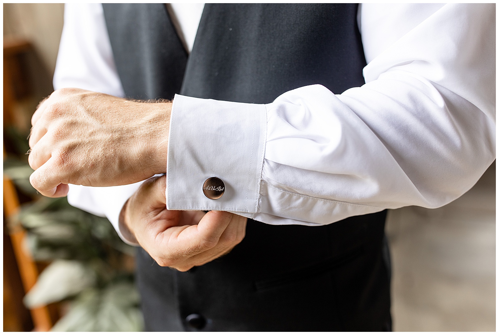 close up photo of groom's left arm as he adjusts his cuff link before wedding ceremony at stoltzfus homestead and gardens