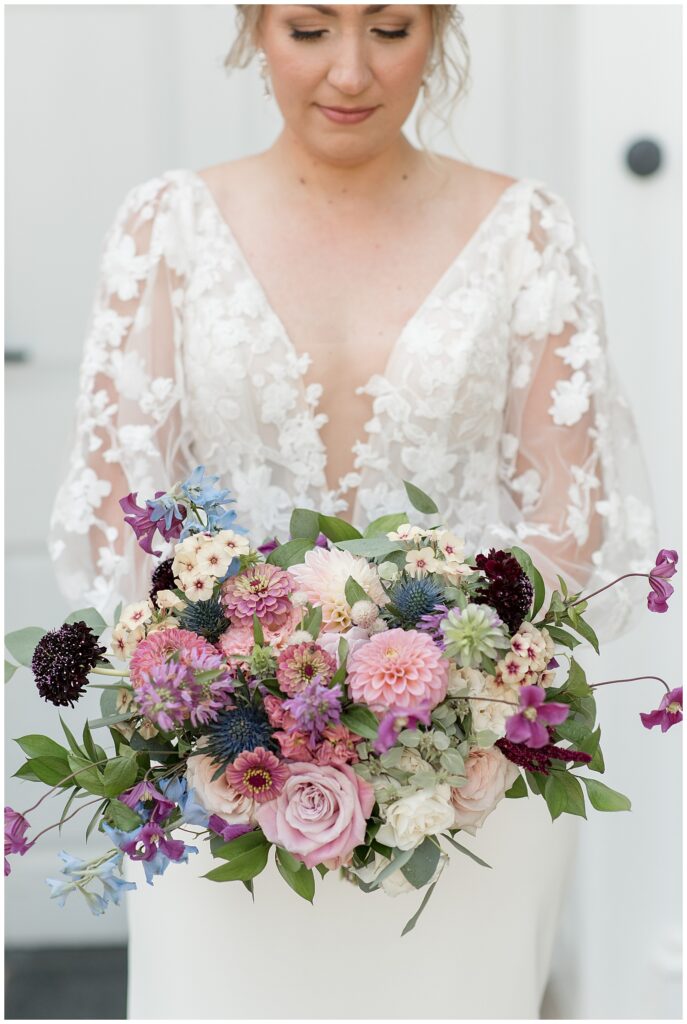closeup photo of bride holding her maroon, pink, and navy blue bridal bouquet in lancaster county