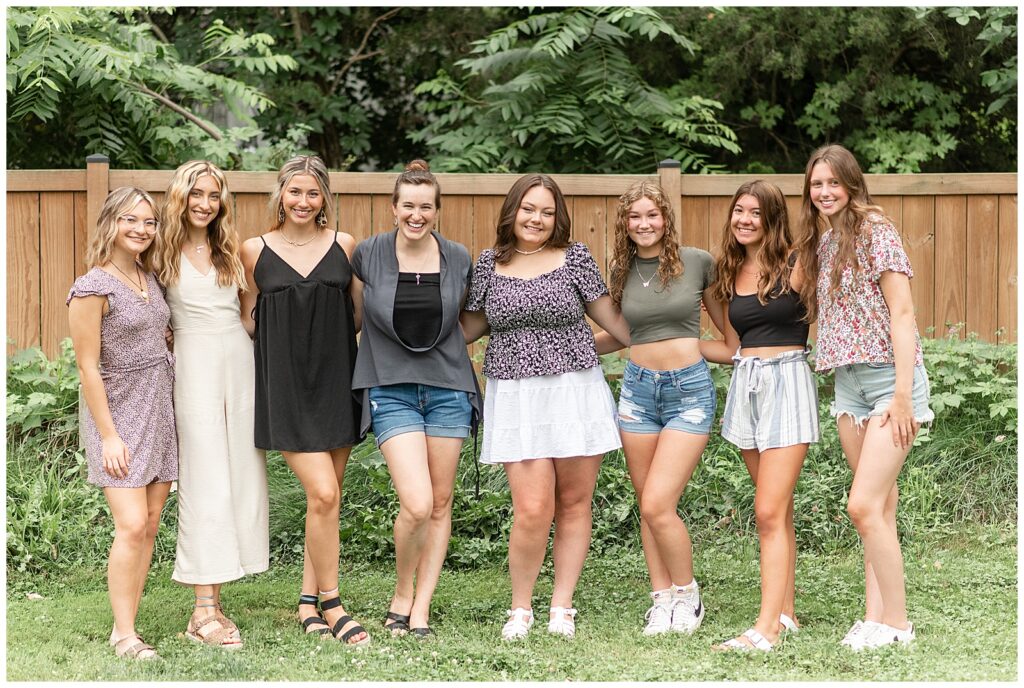 six senior girls with arms around each other smiling each with a knee bent in lancaster pa