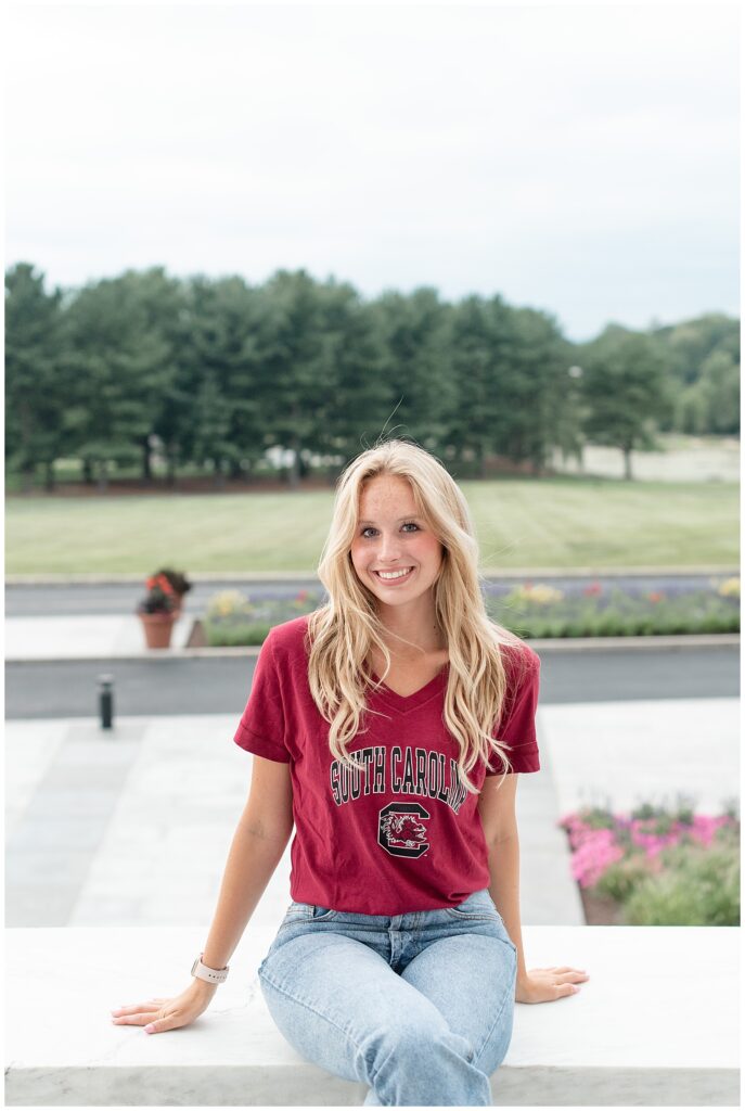 senior girl sitting on wall wearing university of south carolina t-shirt in hershey pennsylvania