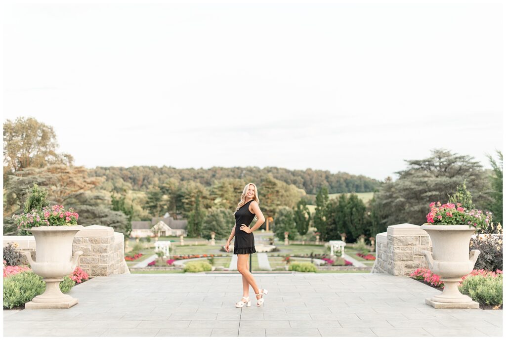 senior girl standing in middle of pathway that overlooks large masonic village property and manicured lawn in elizabethtown pa