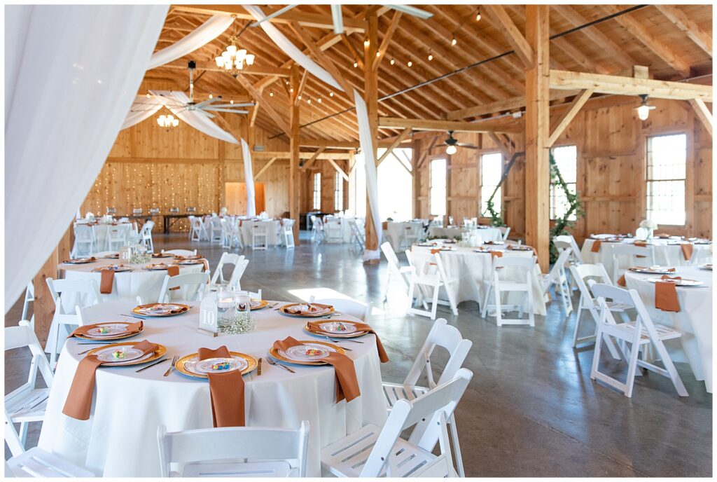 indoor barn space beautifully decorating for wedding reception at pond view farm