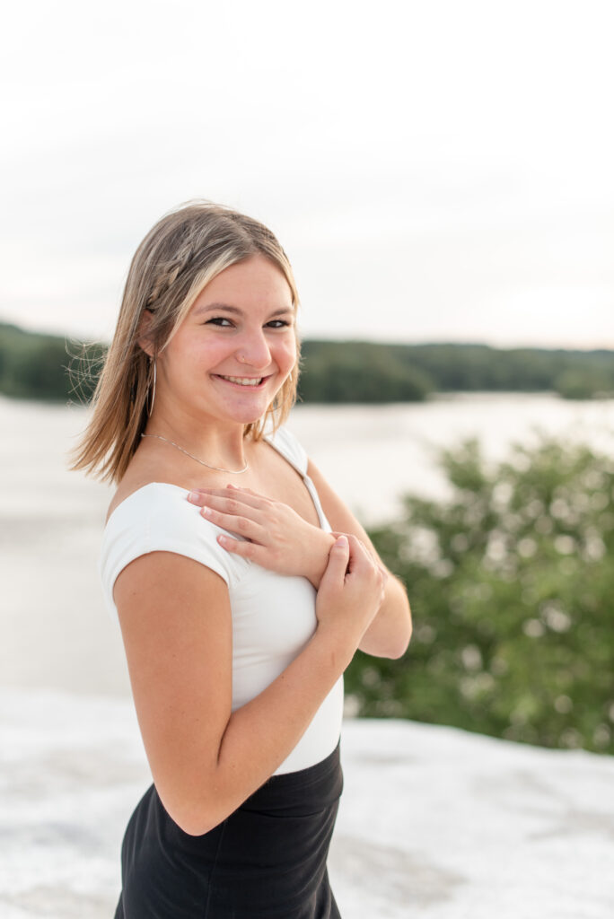 senior girl with right shoulder towards camera and left hand touching right shoulder at the white cliffs of conoy