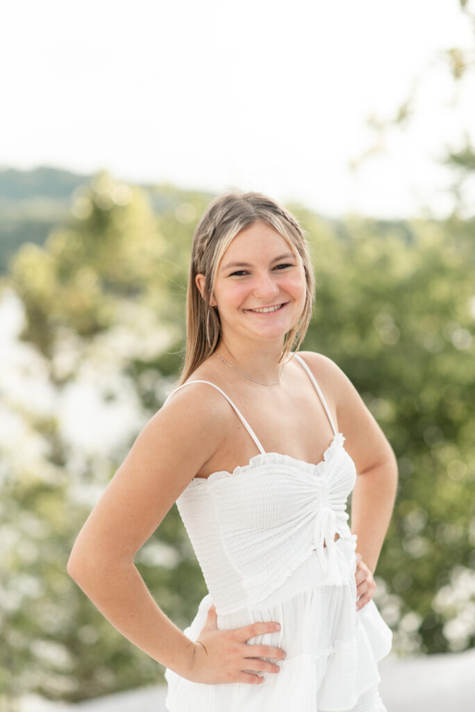 closeup photo of senior spokesmodel with right shoulder towards camera and both hands on hips at white cliffs of conoy in lancaster pennslvania