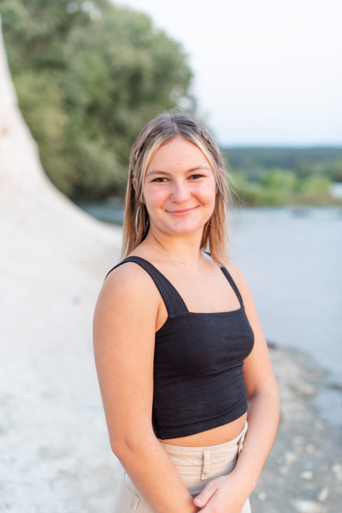 closeup of senior girl smiling at camera with white rock and river behind her at the white cliffs of conoy