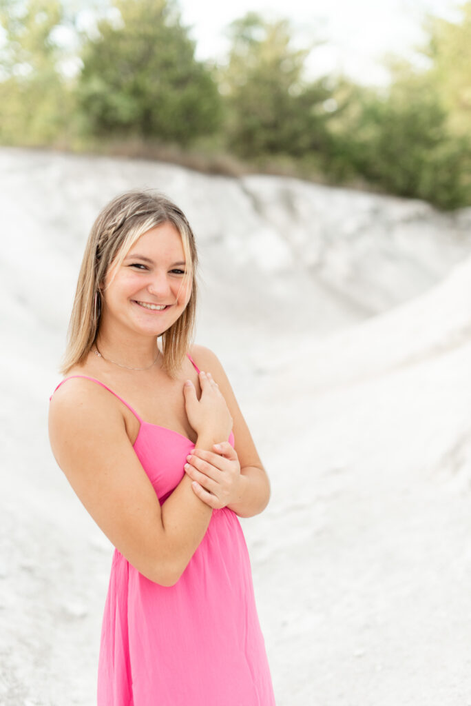 senior spokesmodel with right shoulder towards camera and right hand on left shoulder smiling at camera in lancaster county