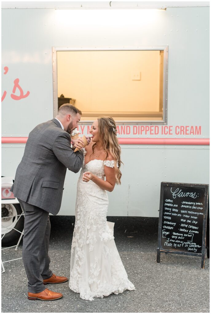 couple enjoying ice cream cones from penny's ice cream truck during their reception at lakefield weddings