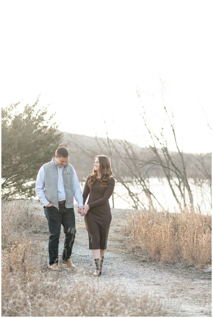 engaged couple holding hands and walking towards camera at sunset at the white cliffs of conoy