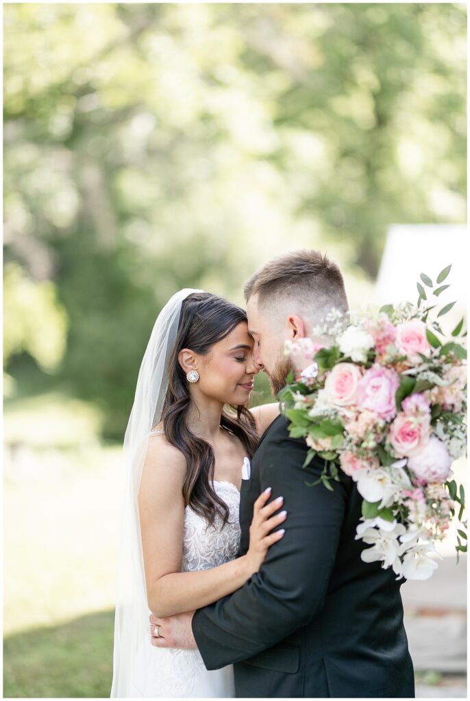 couple hugging with their foreheads touching on sunny day in macungie pennsylvania