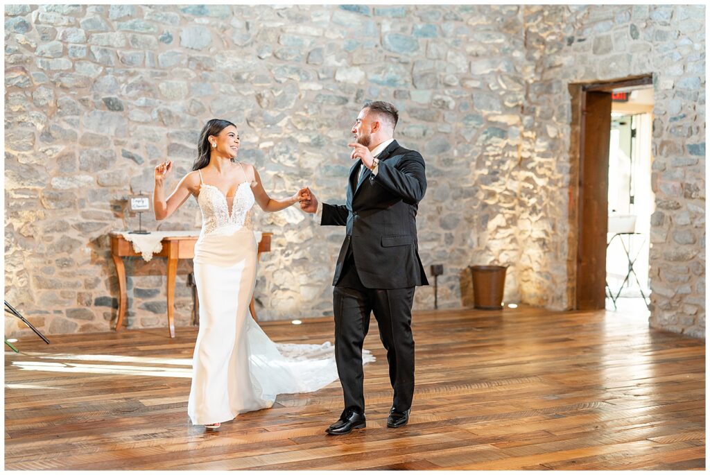 couple walking into to their barn wedding reception at domain pterion in pennsylvania