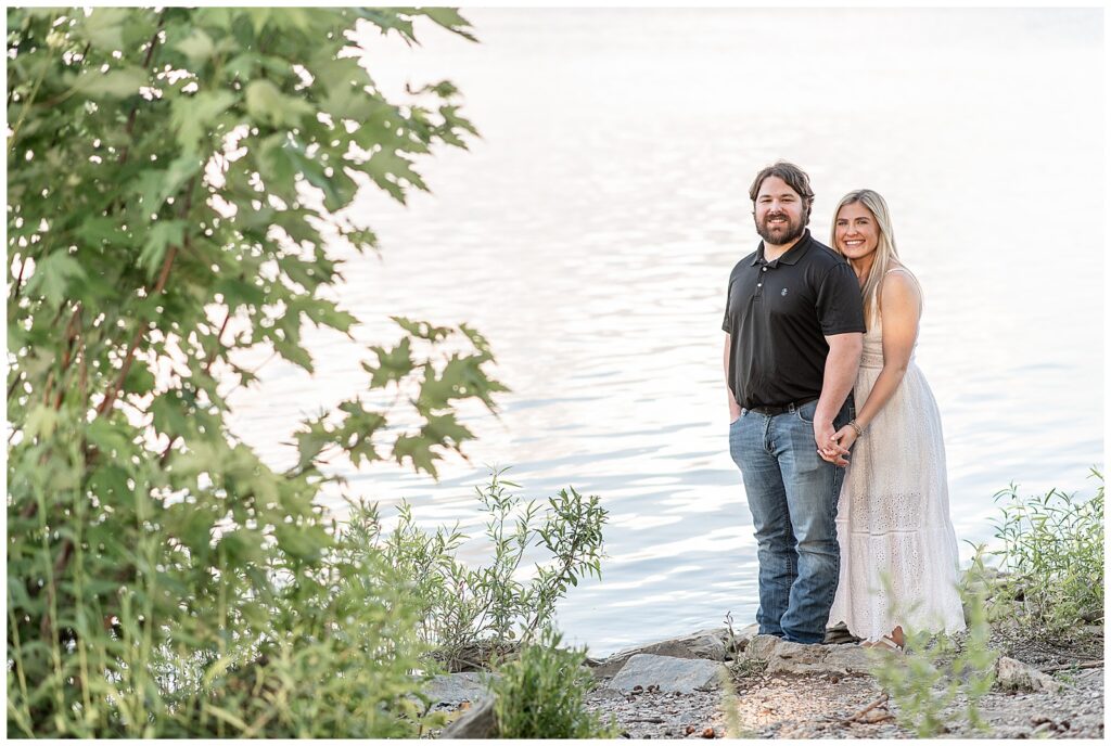 woman standing behind man as they hold hands by susquehanna river in york county pennsylvania