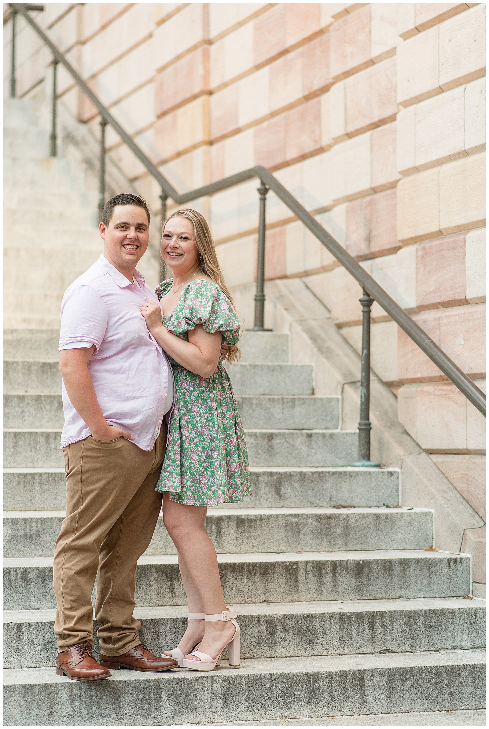 engaged couple hugging on steps of county courthouse in lancaster city on summer evening