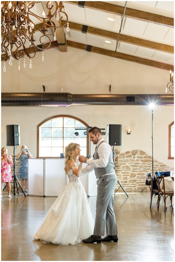 couple sharing their first dance inside reception room at folino estate winery