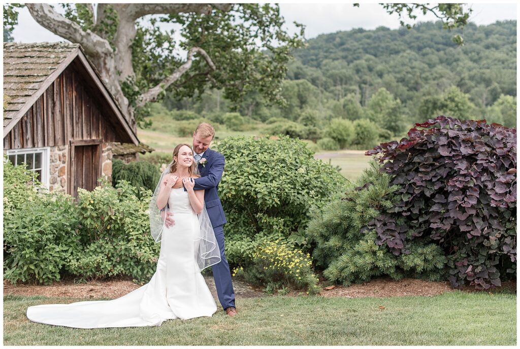 French Creek Golf Club wedding bride and groom portraits with him wrapped up from behind her