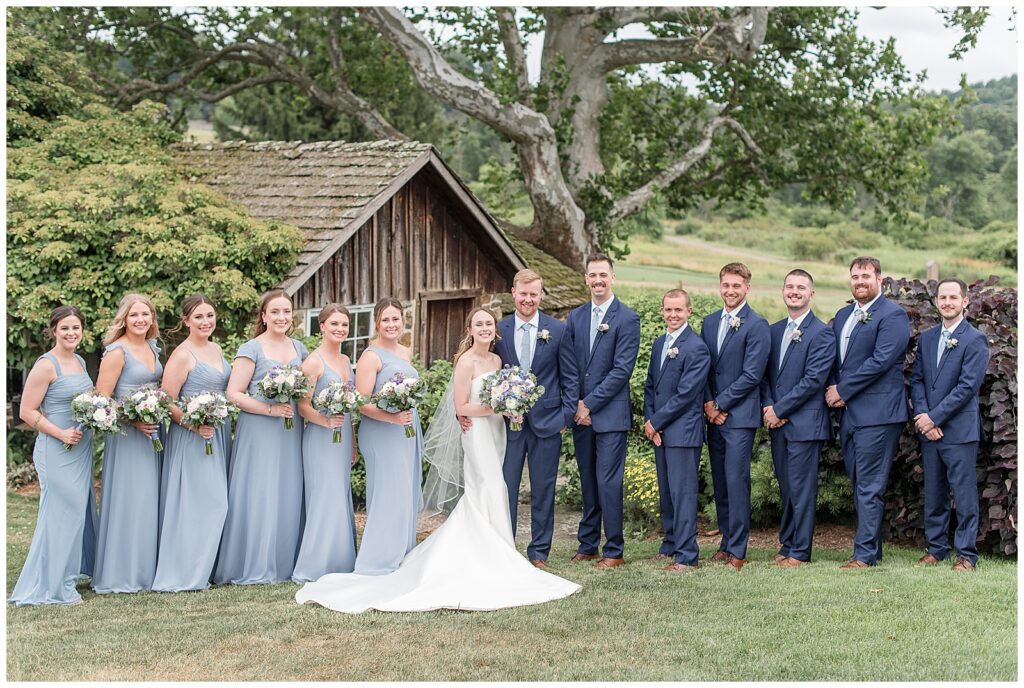 wedding party portrait with bridesmaids in light blue and groomsmen in navy