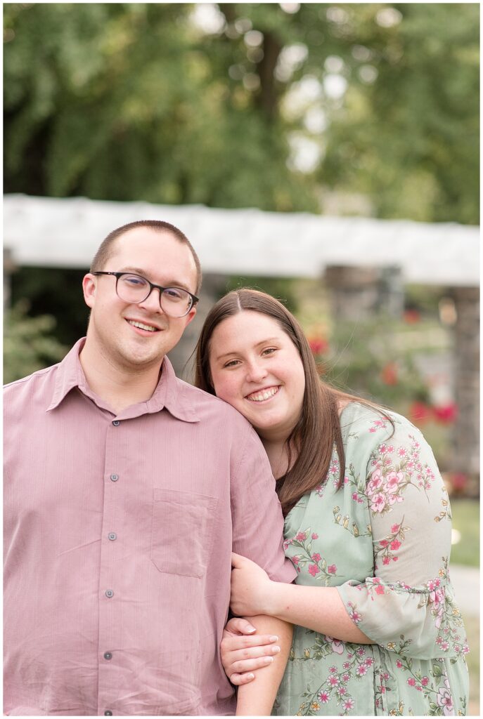 woman holding onto man's left arm and resting her cheek against him as they smile at camera in lancaster pennsylvania