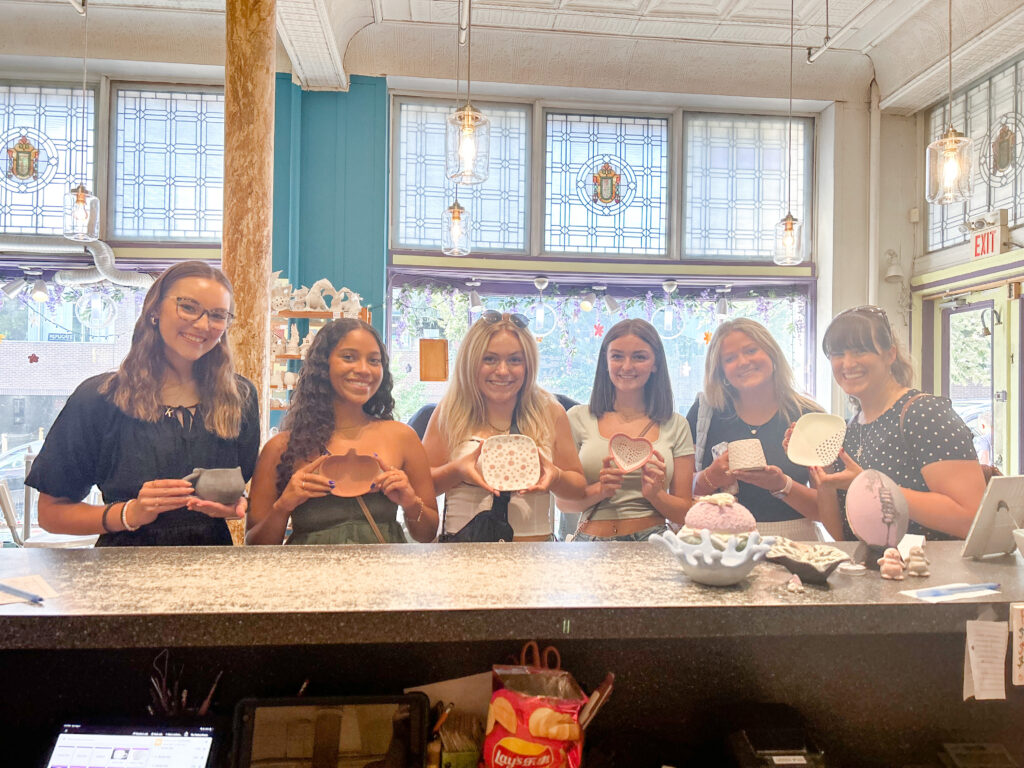 five senior girl spokesmodels and heather showing off their pottery pieces at pottery works in downtown lancaster