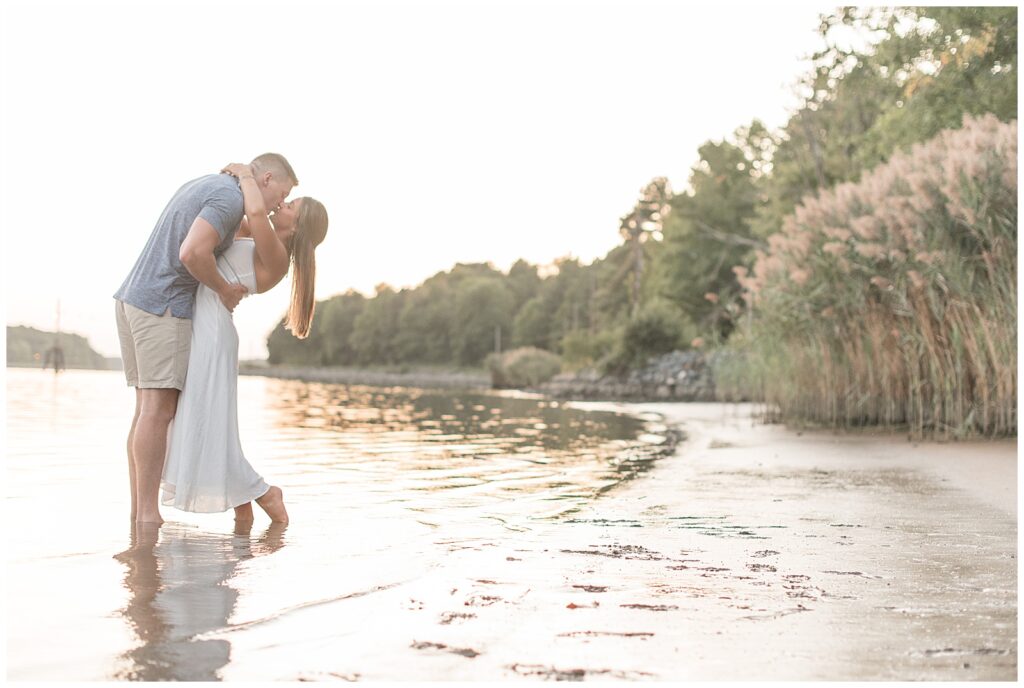 couple kissing along beach at sunset in maryland 