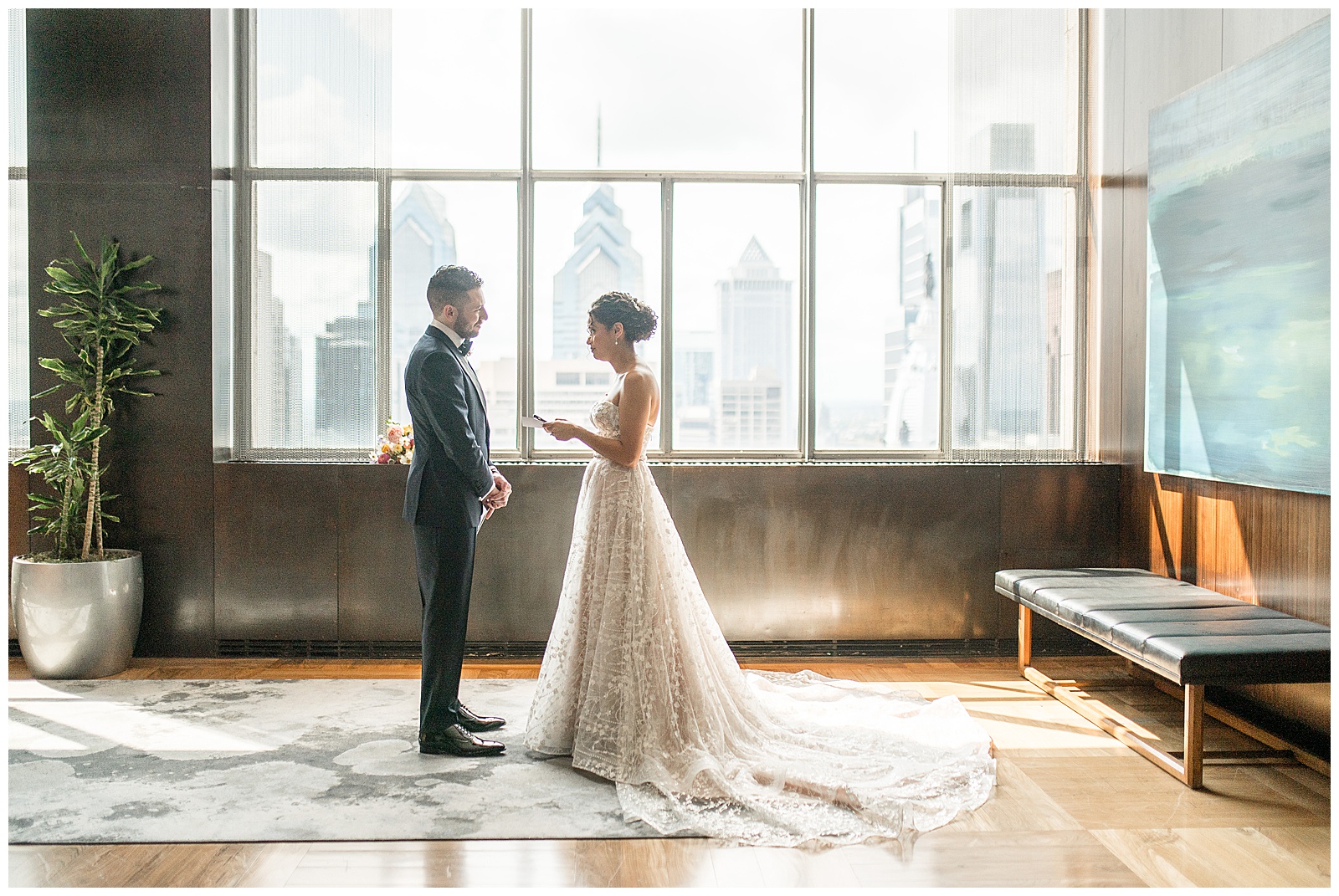 bride reading her vows to her groom before ceremony in room with large windows and wooden floor at cescaphe