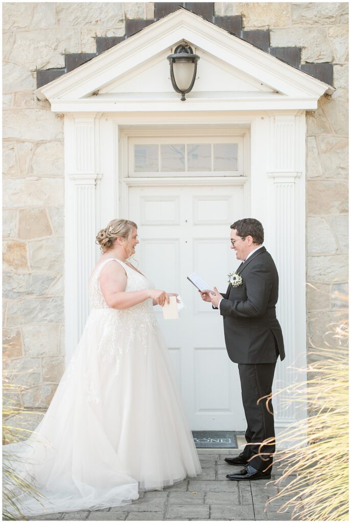 bride and groom facing each other after first look moment on wedding day at the barn at silverstone