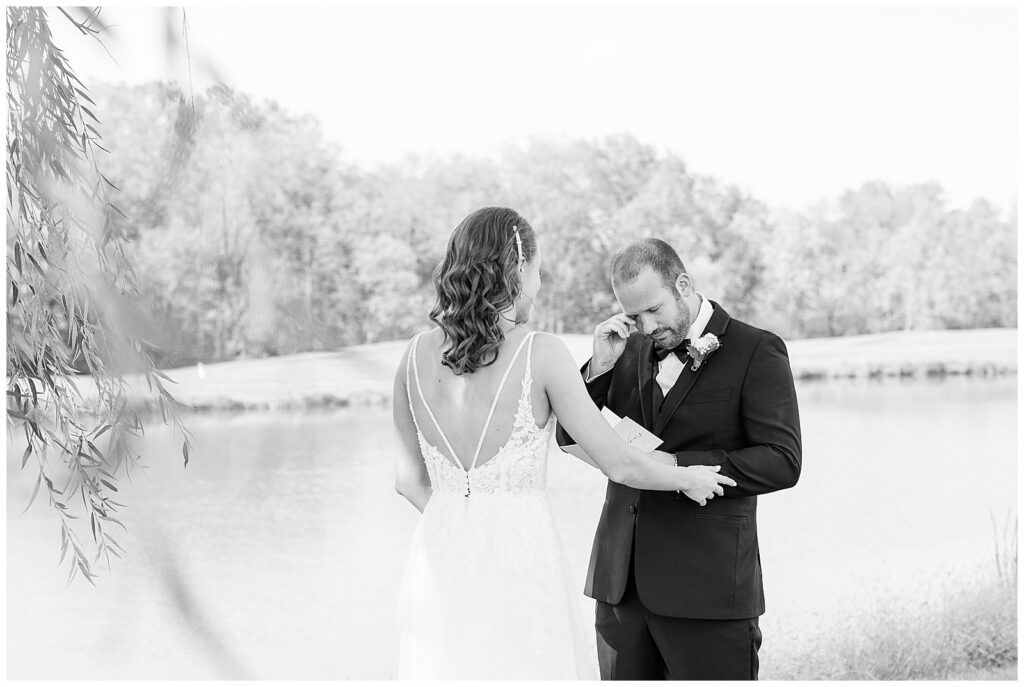 black and white photo of first look moment by pond at the links at gettysburg in pennsylvania