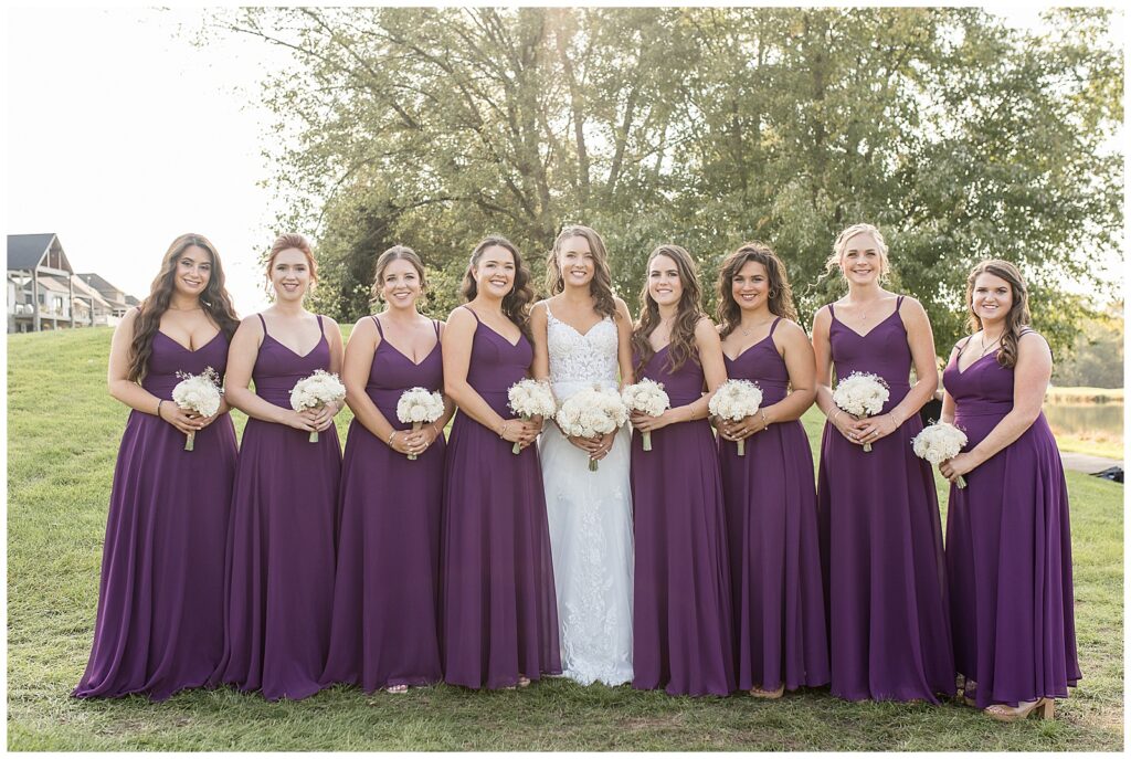 bride with her eight bridesmaids all holding white bouquets of flowers at the links at gettysburg in pennsylvania