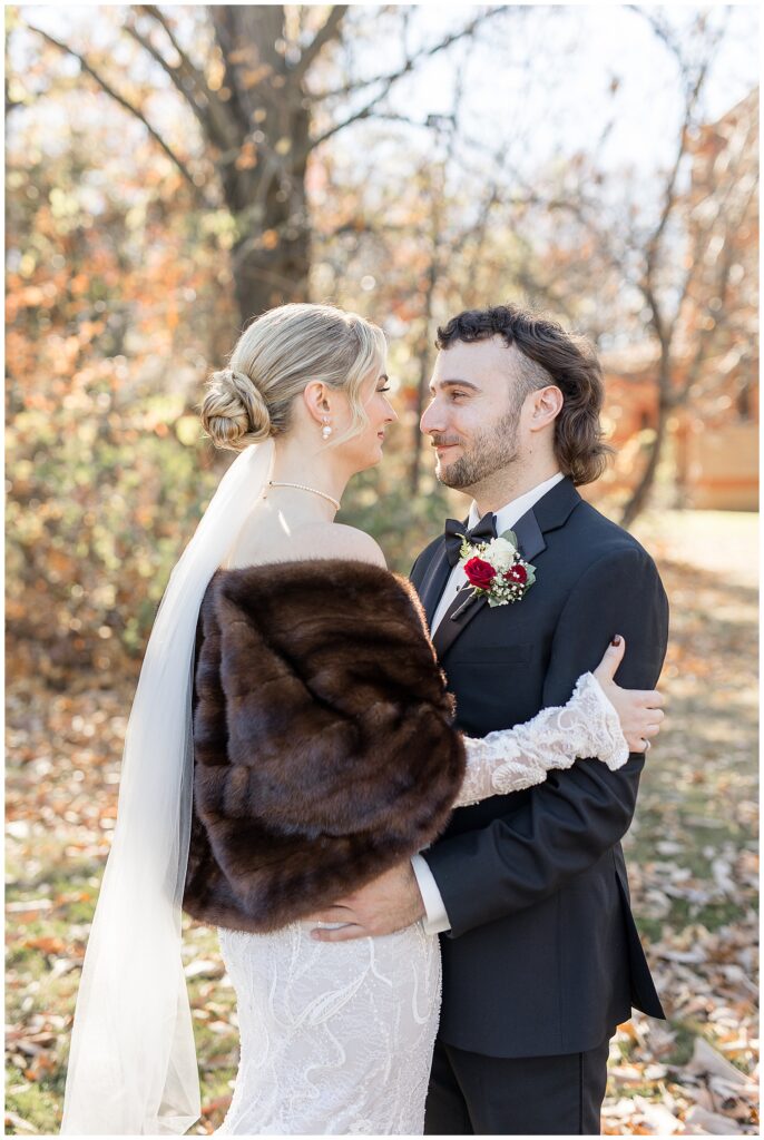 bride and groom hugging and looking at one another on fall day in york pennsylvania