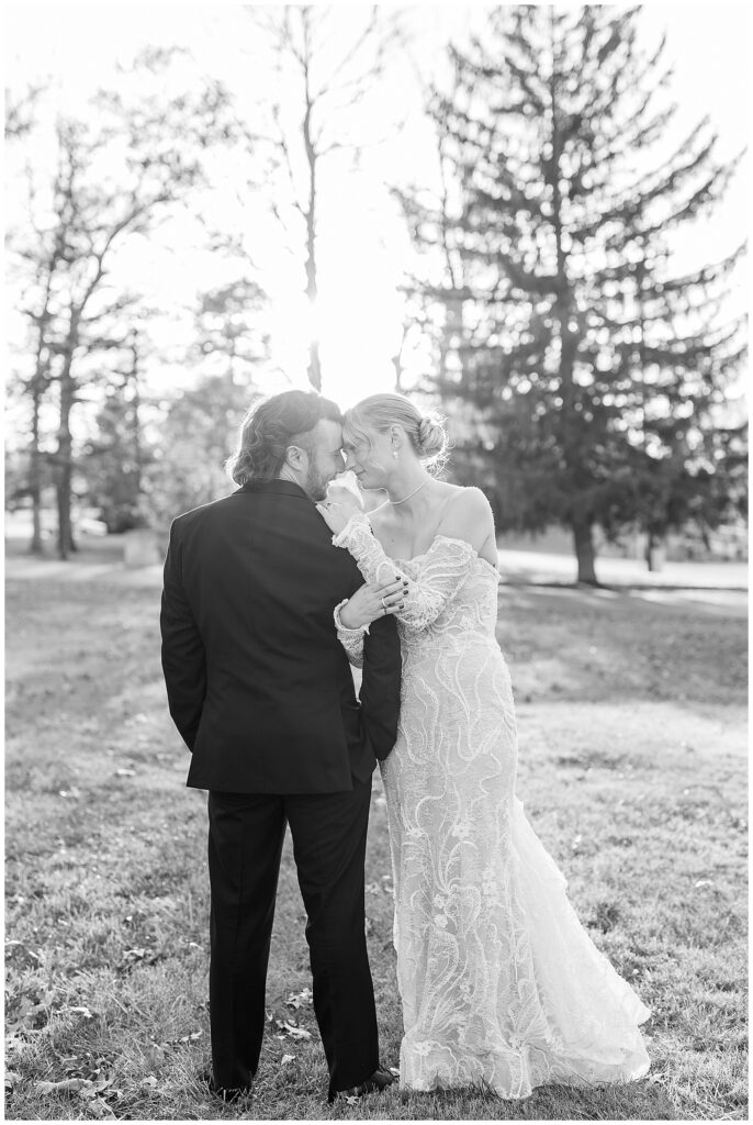 black and white photo of bride and groom touching foreheads together at sunset on fall day in york pennsylvania