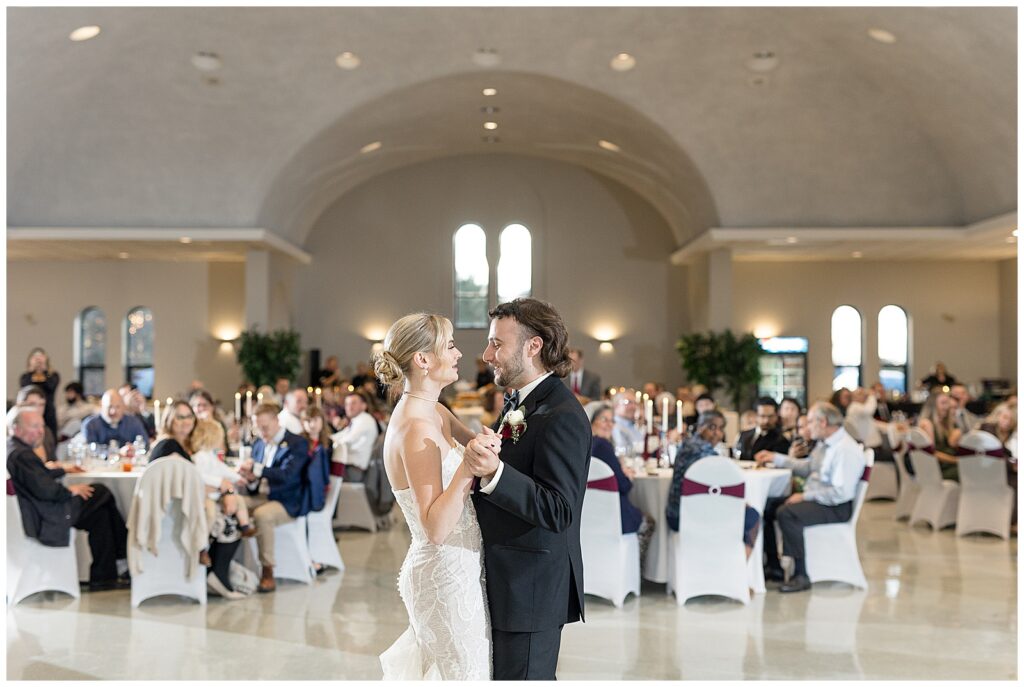 couple sharing their first dance at reception at annunciation greek orthodox church in york pennsylvania as their guests watch them