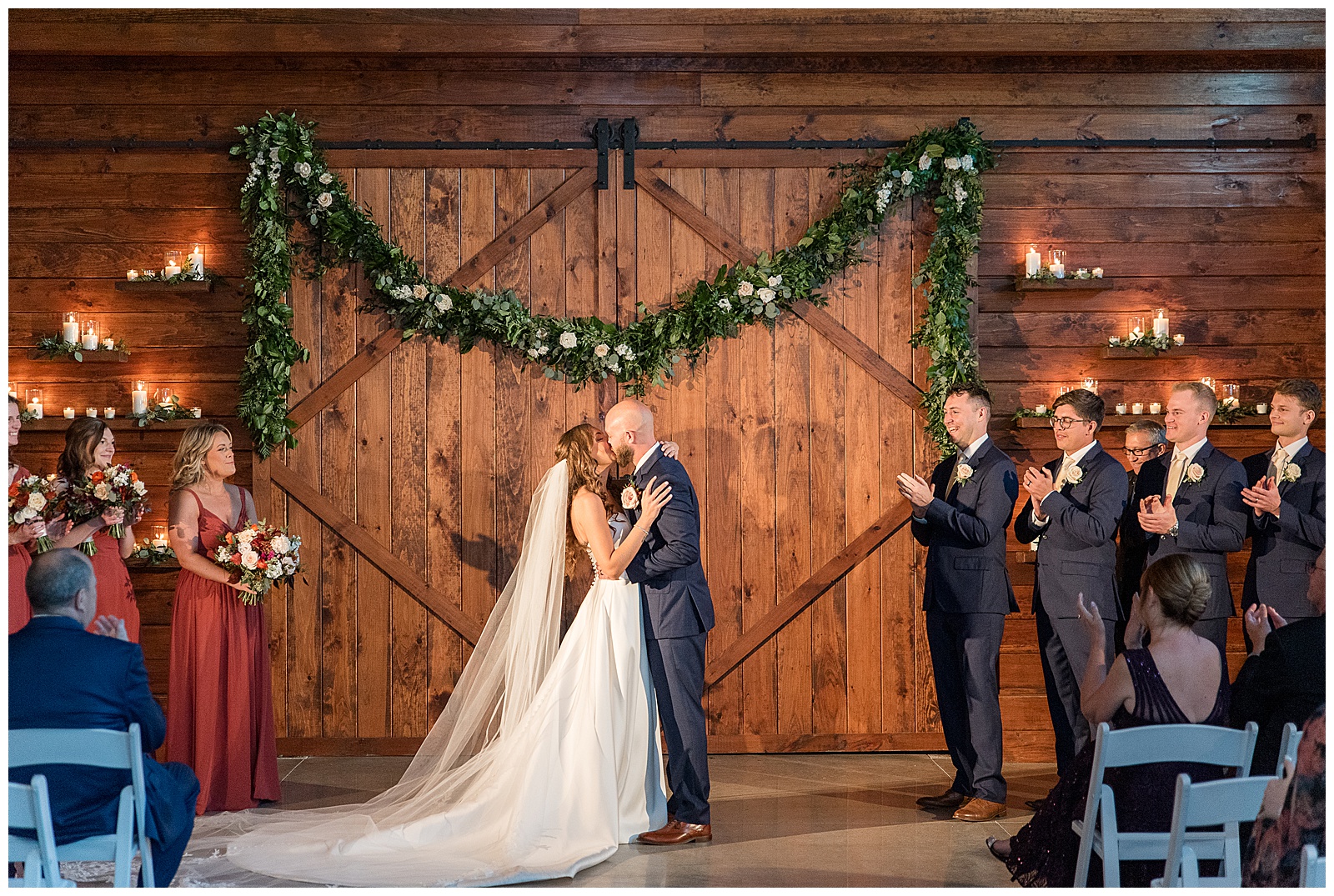 couple sharing their first kiss moment inside barn wedding at the barn at silverstone