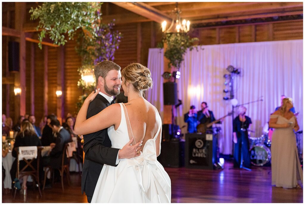 couple sharing their first dance inside barn reception at the star barn at stone gables estate